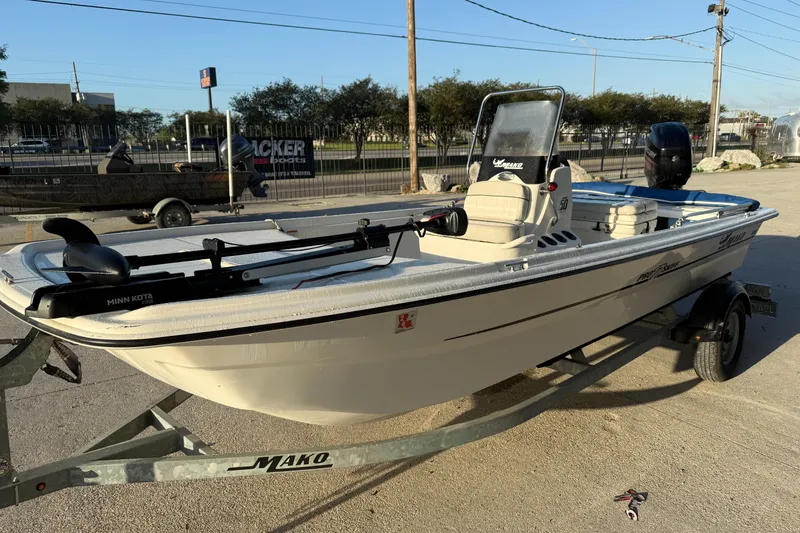 Slide: The Image of 2017 Mako Pro Skiff 17 CC boat on trailer, equipped with Minn Kota motor. - 7