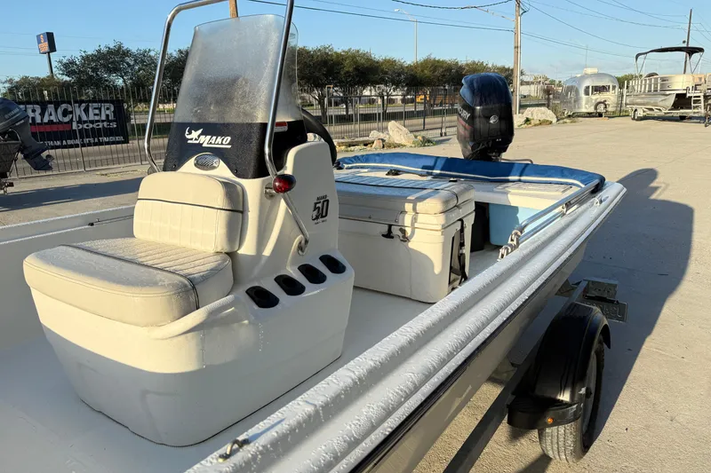 Slide: The Image of 2017 Mako Pro Skiff 17 CC boat with seating and outboard motor. - 8