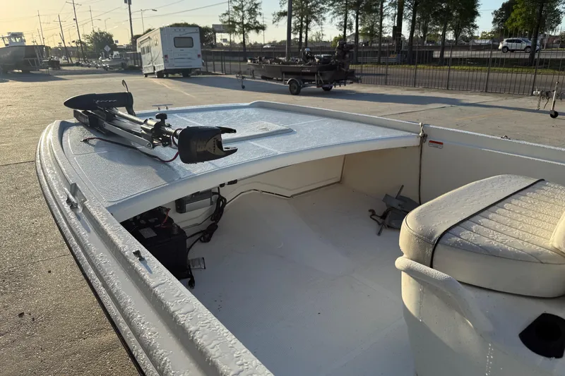 Slide: The Image of 2017 Mako Pro Skiff 17 CC boat with trolling motor and seating, parked outdoors. - 9