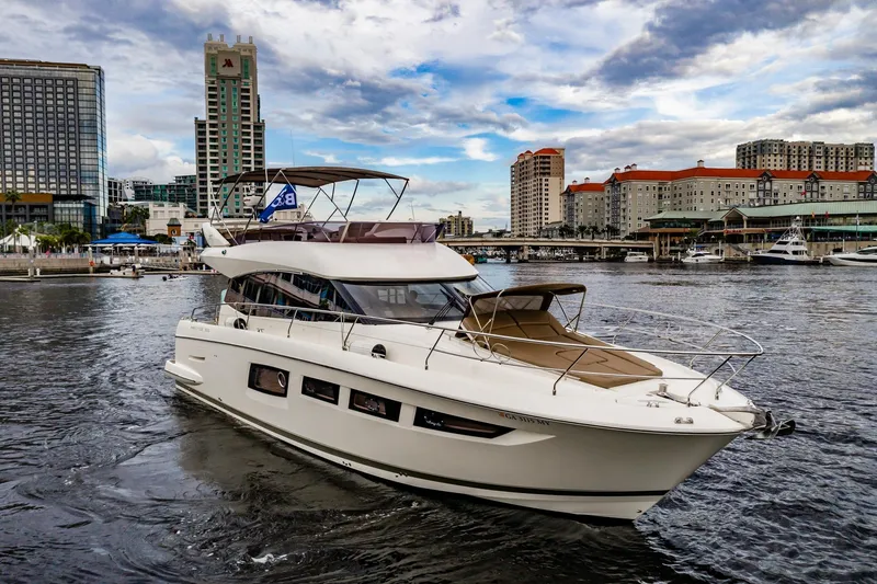 The Image of 2013 Prestige 500 Fly yacht cruising in urban waterfront setting with city skyline. - 0