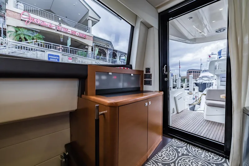 Slide: The Image of Interior view of 2013 Prestige 500 Fly yacht with marina and restaurant in background. - 20