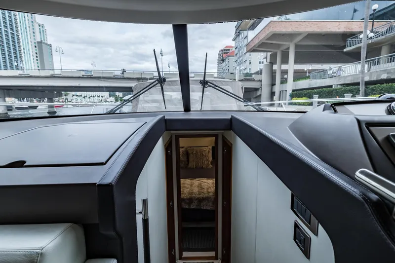 Slide: The Image of Interior view of 2013 Prestige 500 Fly yacht cockpit with cityscape background. - 22