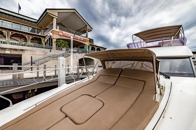 Slide: The Image of Prestige 500 Fly 2013 yacht docked near a waterfront building under cloudy skies. - 37