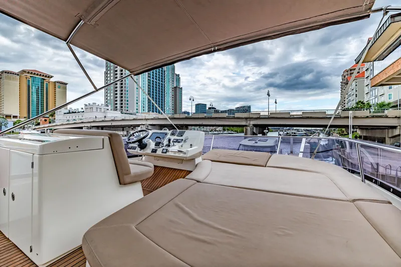 Slide: The Image of Prestige 500 Fly 2013 yacht with spacious deck, cityscape view, and modern controls. - 38