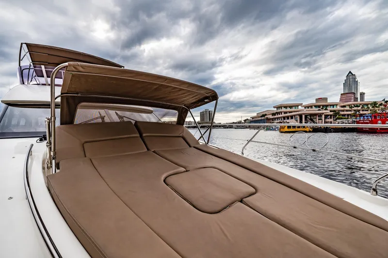 Slide: The Image of Luxurious 2013 Prestige 500 Fly yacht with sunbed, docked near urban waterfront. - 39