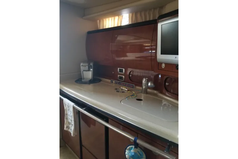 Slide: The Image of 2004 Sea Ray 360 Sundancer interior kitchen with countertop, sink, and appliances. - 10