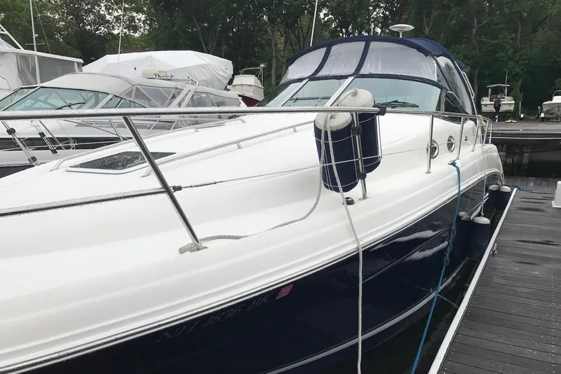 Slide: The Image of 2004 Sea Ray 360 Sundancer docked at marina, featuring sleek design and white hull. - 5