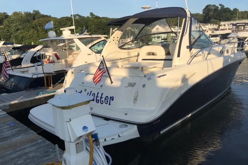Slide: The Image of 2004 Sea Ray 360 Sundancer yacht docked at marina with American flag. - 6