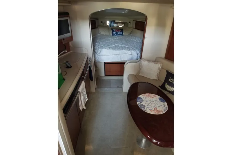 Slide: The Image of Interior of 2004 Sea Ray 360 Sundancer yacht with cozy seating and sleeping area. - 9