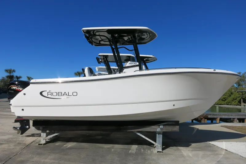 The Image of 2026 Robalo R230 Center Console boat on display under clear blue sky. - 0