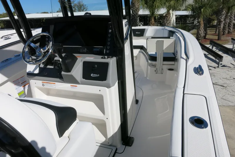Slide: The Image of 2026 Robalo R230 Center Console boat interior with steering wheel and seating area. - 13
