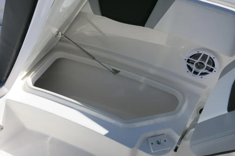 Slide: The Image of 2026 Robalo R230 Center Console boat storage compartment with speaker detail. - 16