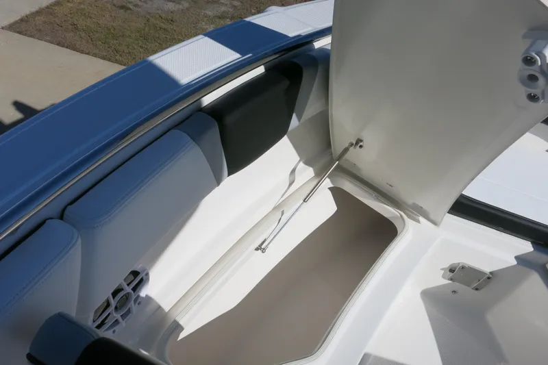 Slide: The Image of 2026 Robalo R230 Center Console boat storage compartment open, showcasing interior space. - 17