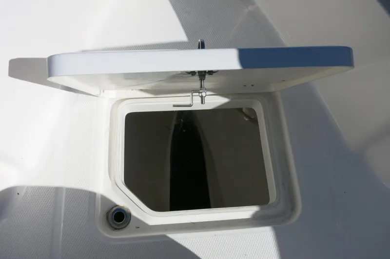 Slide: The Image of Open hatch on 2026 Robalo R230 Center Console boat deck. - 19