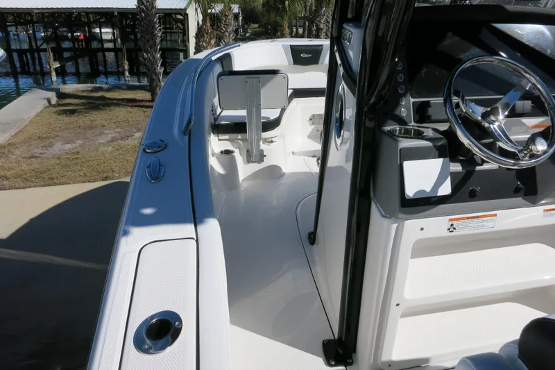 Slide: The Image of 2026 Robalo R230 Center Console boat interior with steering wheel and seating area. - 22