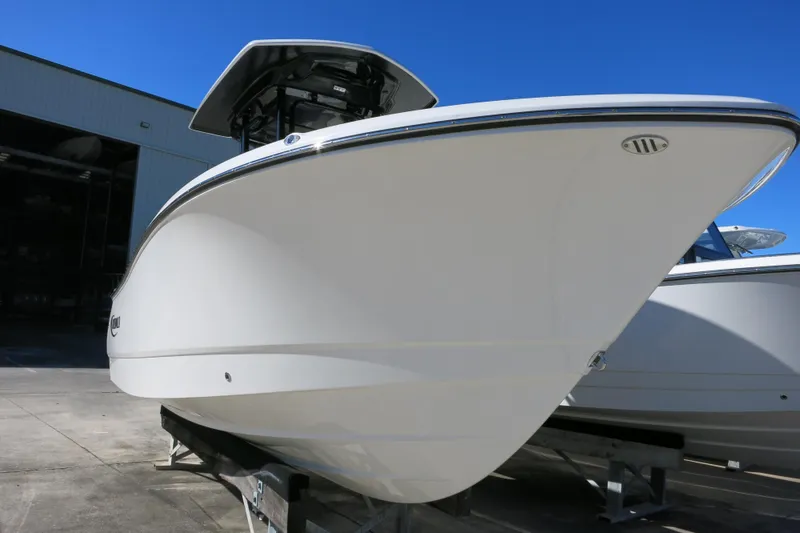 Slide: The Image of 2026 Robalo R230 Center Console boat on display in a marina setting. - 3
