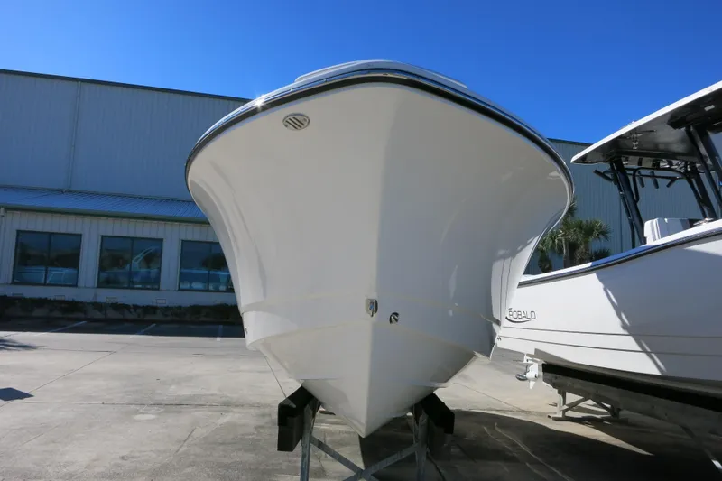 Slide: The Image of 2026 Robalo R230 Center Console boat displayed outdoors on a sunny day. - 4