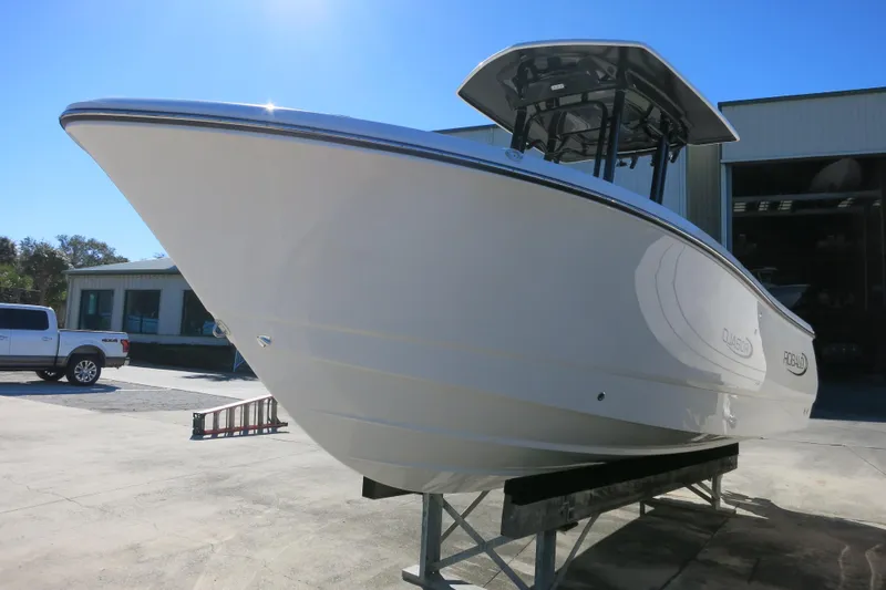 Slide: The Image of 2026 Robalo R230 Center Console boat displayed outdoors on a sunny day. - 5