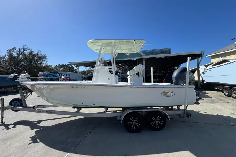 The Image of 2019 Sea Hunt BX 22 BR boat on trailer under clear blue sky. - 1