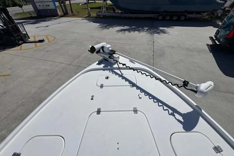 Slide: The Image of 2019 Sea Hunt BX 22 BR boat deck with trolling motor in a marina setting. - 18