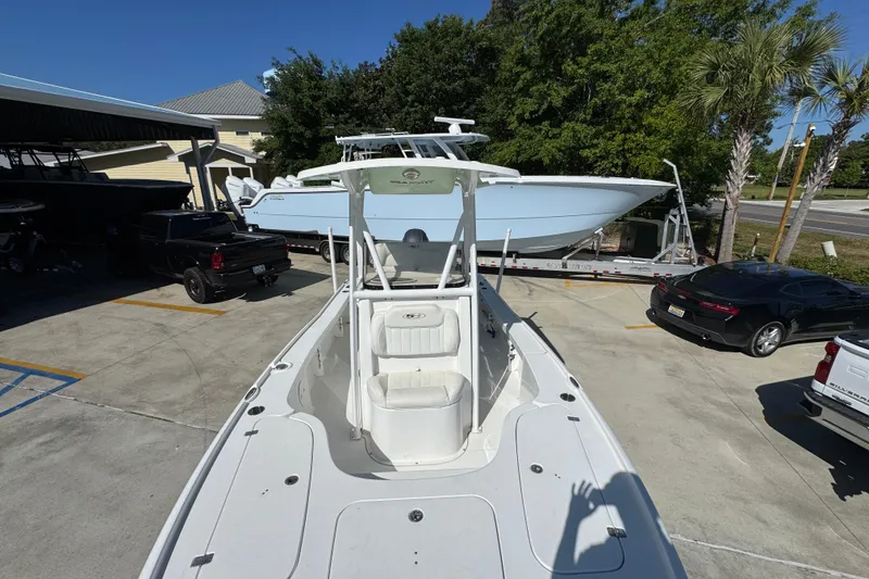 Slide: The Image of 2019 Sea Hunt BX 22 BR boat parked in a lot with surrounding vehicles. - 20