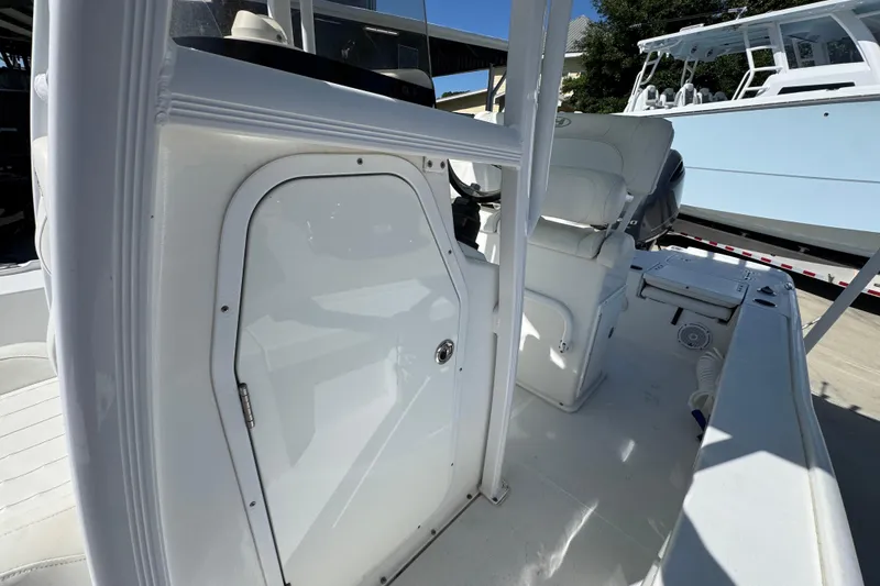 Slide: The Image of 2019 Sea Hunt BX 22 BR boat interior, featuring white seating and storage compartments. - 22