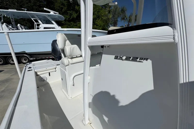 Slide: The Image of 2019 Sea Hunt BX 22 BR boat interior with seating and console details. - 23