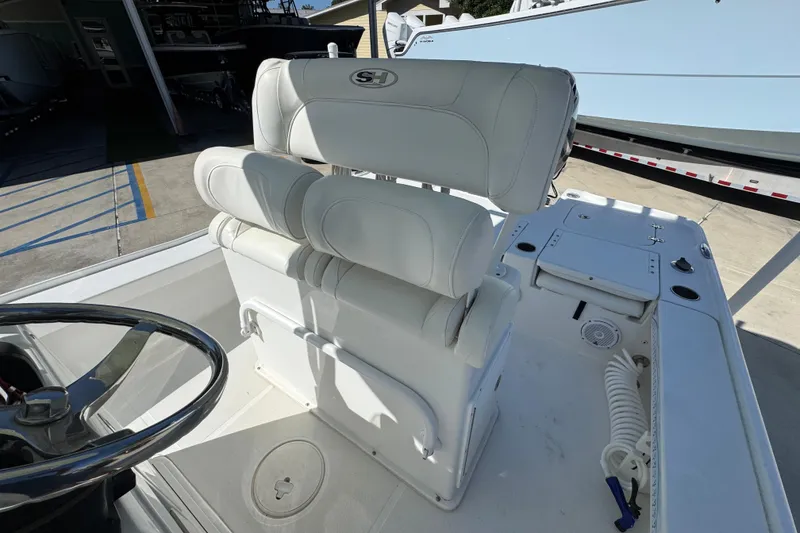 Slide: The Image of 2019 Sea Hunt BX 22 BR boat interior with white seating and steering wheel. - 24