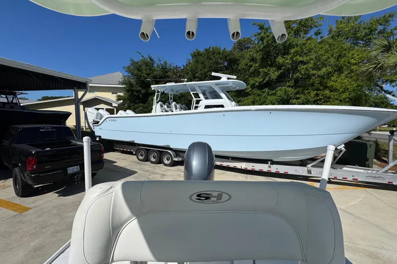 Slide: The Image of 2019 Sea Hunt BX 22 BR boat on trailer, parked beside a black truck. - 26