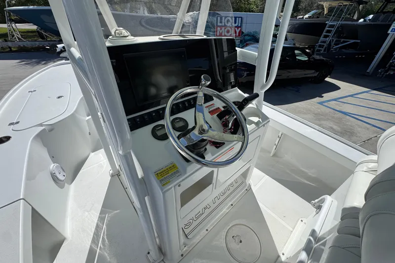 Slide: The Image of 2019 Sea Hunt BX 22 BR boat cockpit with steering wheel and control panel. - 28