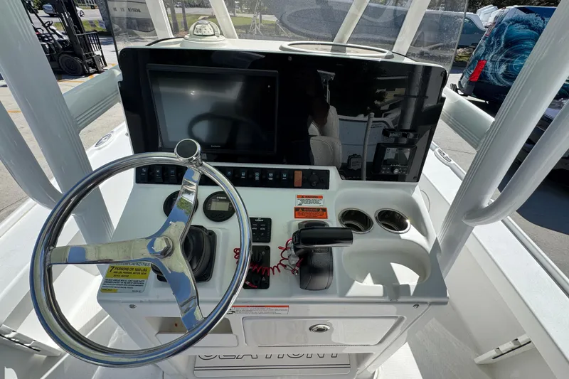Slide: The Image of 2019 Sea Hunt BX 22 BR boat console with steering wheel and navigation controls. - 29