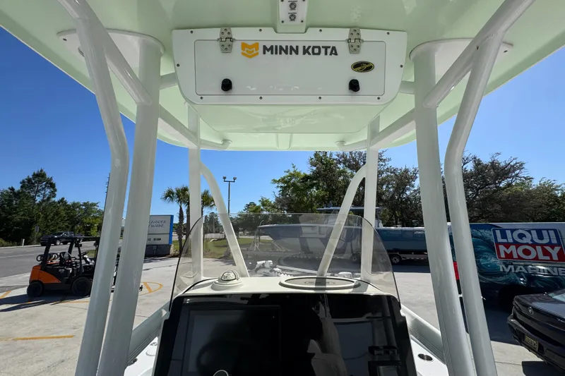 Slide: The Image of 2019 Sea Hunt BX 22 BR boat with Minn Kota equipment, parked outdoors under clear blue sky. - 31