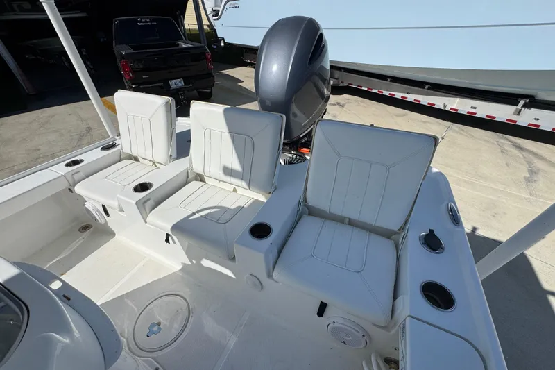 Slide: The Image of 2019 Sea Hunt BX 22 BR boat interior with white seating and motor. - 35