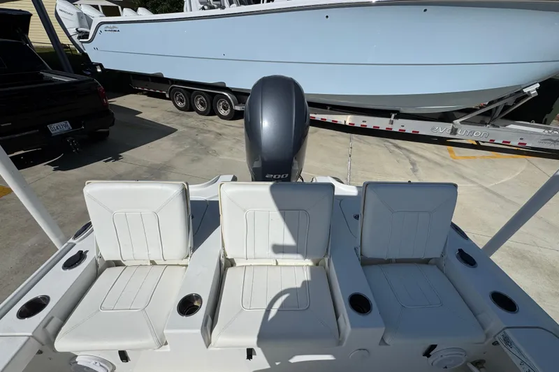 Slide: The Image of 2019 Sea Hunt BX 22 BR boat with three white seats and a Yamaha 200 engine. - 36