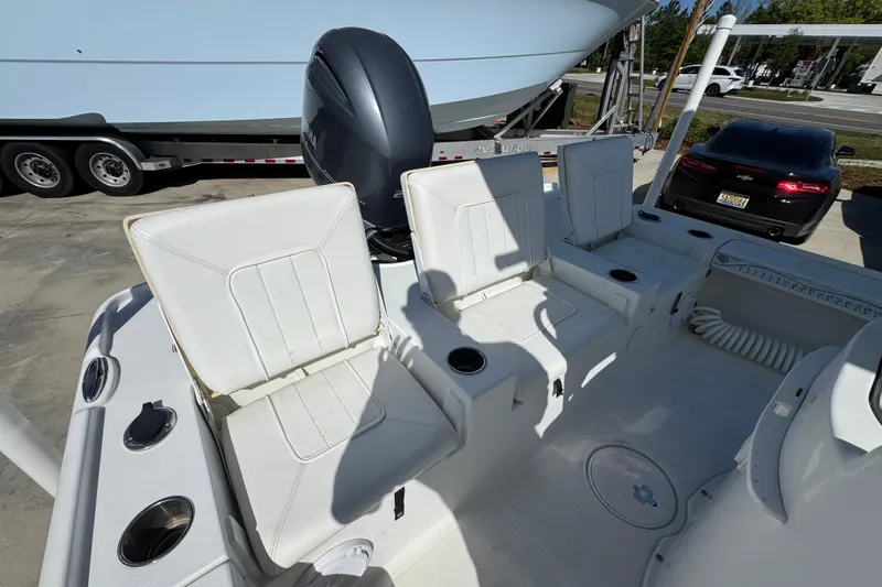 Slide: The Image of 2019 Sea Hunt BX 22 BR boat interior with white seating and motor. - 37