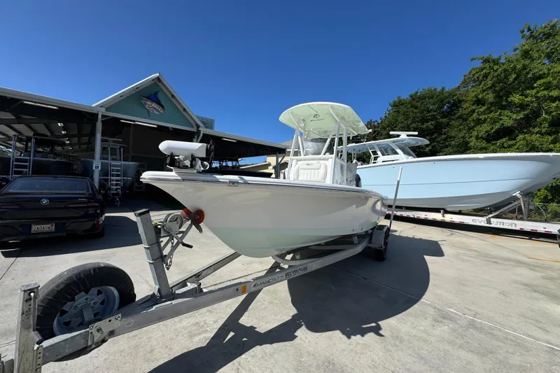 Slide: The Image of 2019 Sea Hunt BX 22 BR boat on trailer, parked outdoors under clear blue sky. - 4