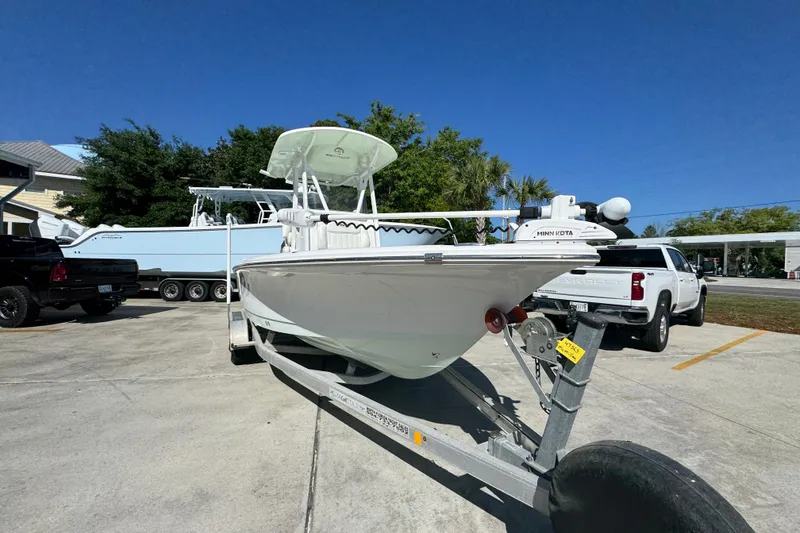 Slide: The Image of 2019 Sea Hunt BX 22 BR boat on trailer, parked outdoors under clear blue sky. - 6