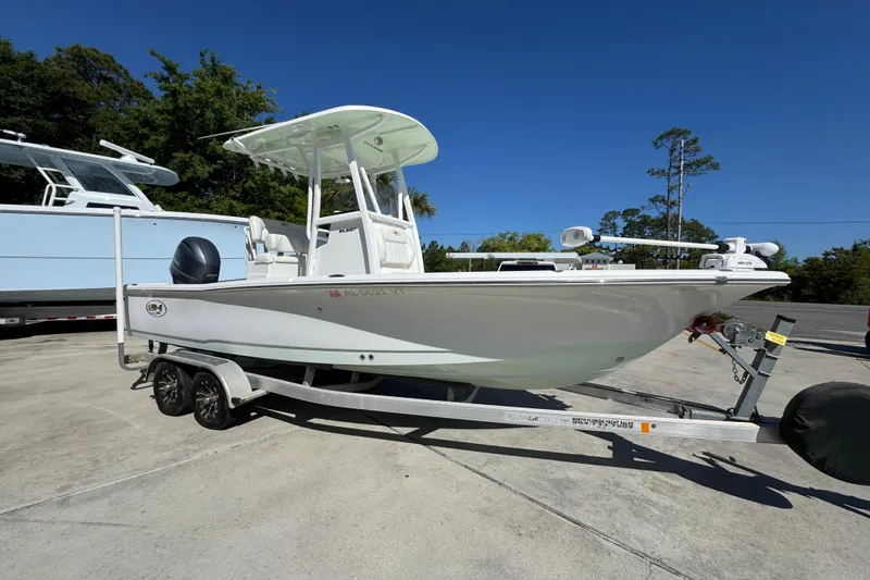 Slide: The Image of 2019 Sea Hunt BX 22 BR boat on trailer, parked outdoors under clear blue sky. - 7