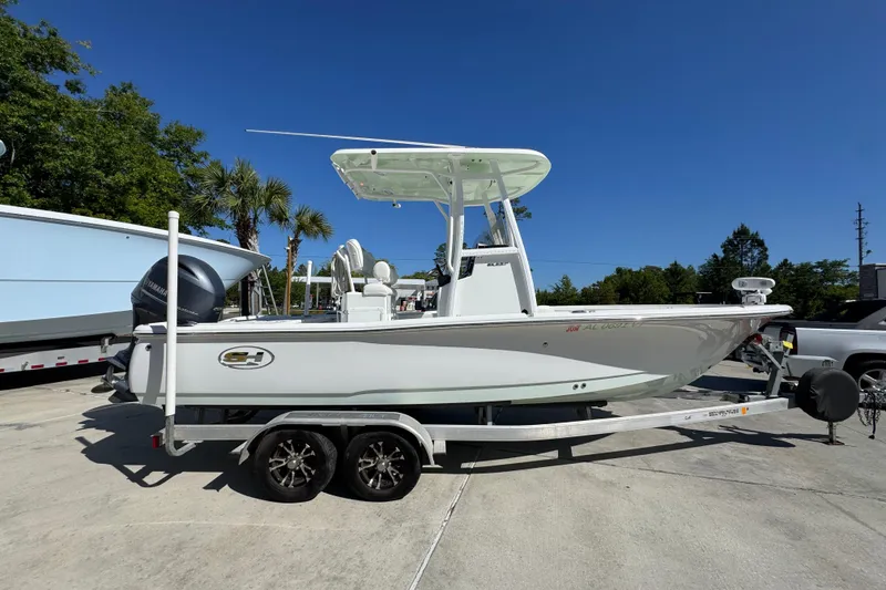 Slide: The Image of 2019 Sea Hunt BX 22 BR boat on trailer, parked outdoors under clear blue sky. - 8