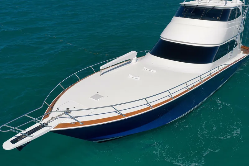 Slide: The Image of 2015 Viking 76 Enclosed Bridge yacht on clear blue water. - 10