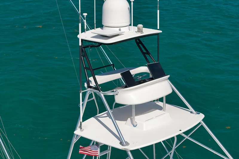 Slide: The Image of 2015 Viking 76 Enclosed Bridge yacht tower against blue ocean backdrop. - 11