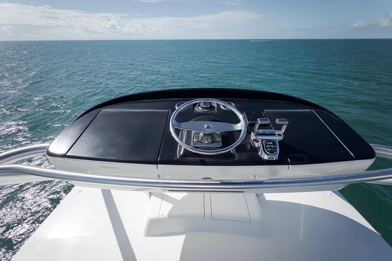 Slide: The Image of Helm of 2015 Viking 76 Enclosed Bridge yacht overlooking the ocean. - 12