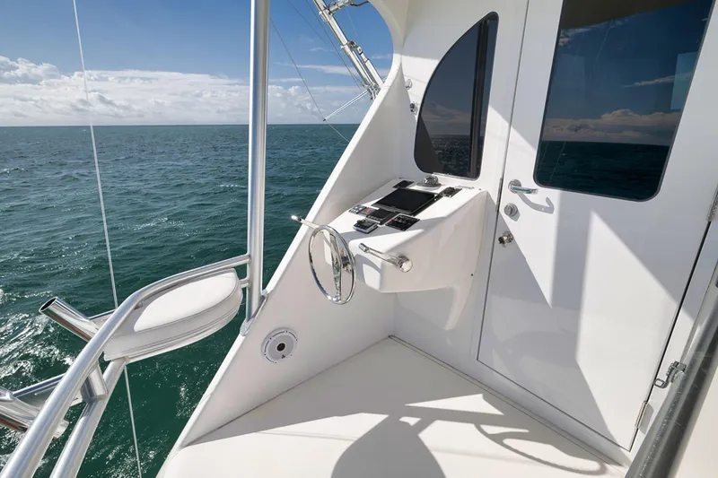 Slide: The Image of 2015 Viking 76 Enclosed Bridge yacht helm with ocean view. - 18