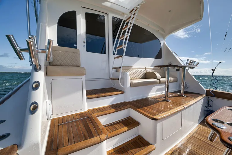 Slide: The Image of Luxurious 2015 Viking 76 Enclosed Bridge yacht with elegant teak deck and seating area. - 19