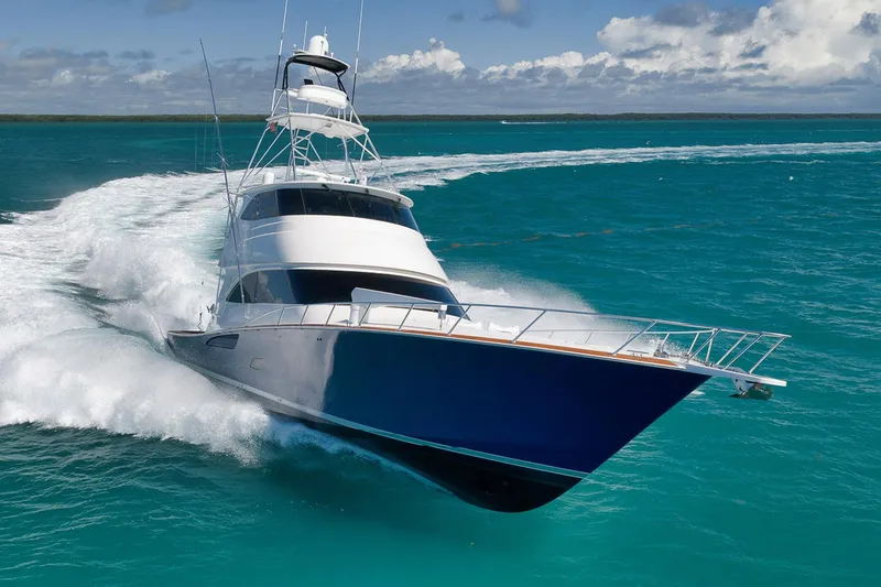 Slide: The Image of 2015 Viking 76 Enclosed Bridge yacht cruising on turquoise ocean waters. - 3