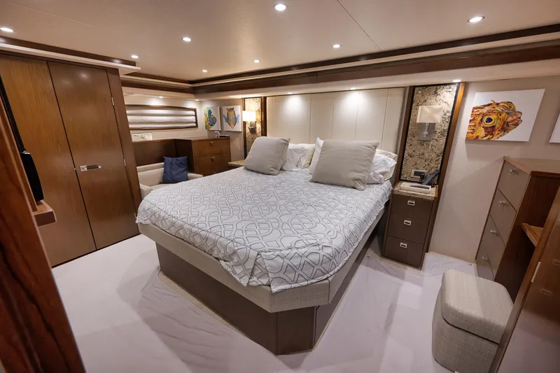 Slide: The Image of Luxurious bedroom interior of 2015 Viking 76 Enclosed Bridge yacht, featuring elegant decor and modern amenities. - 34