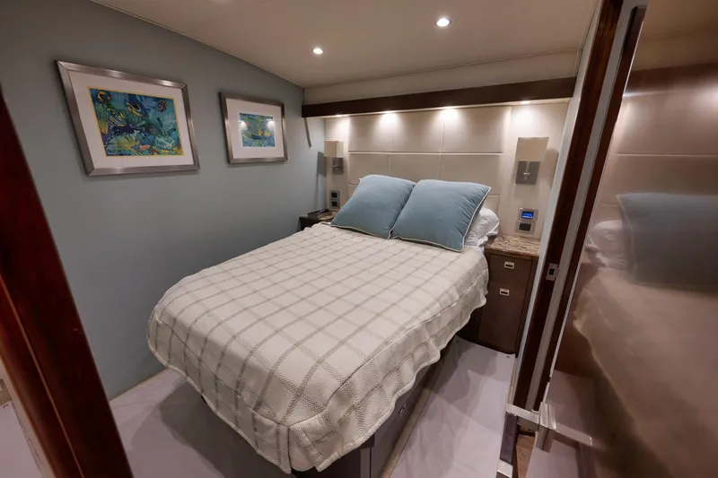 Slide: The Image of Luxurious bedroom interior on 2015 Viking 76 Enclosed Bridge yacht with cozy bedding. - 39