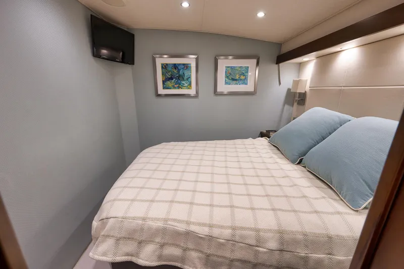 Slide: The Image of Cozy bedroom in 2015 Viking 76 Enclosed Bridge yacht with modern decor and soft lighting. - 40