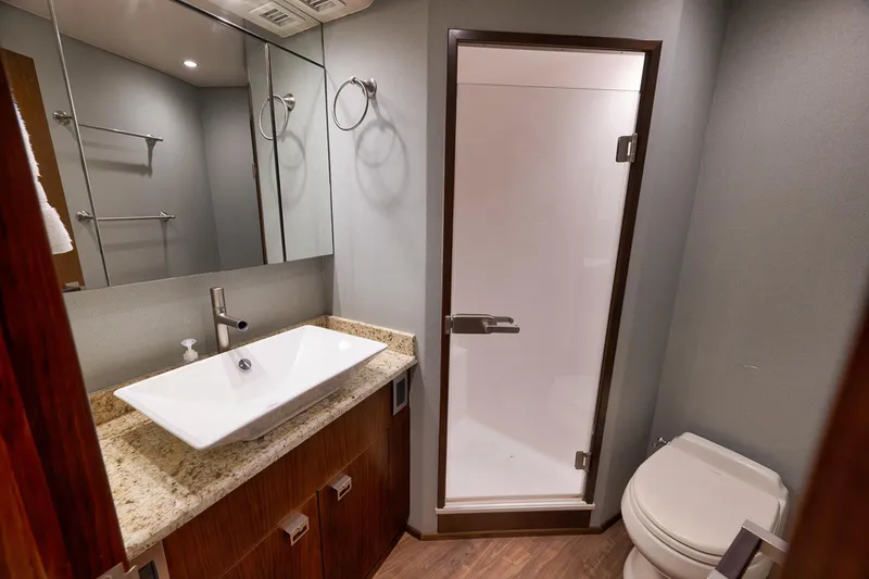 Slide: The Image of Luxurious bathroom in 2015 Viking 76 Enclosed Bridge yacht with modern fixtures. - 41
