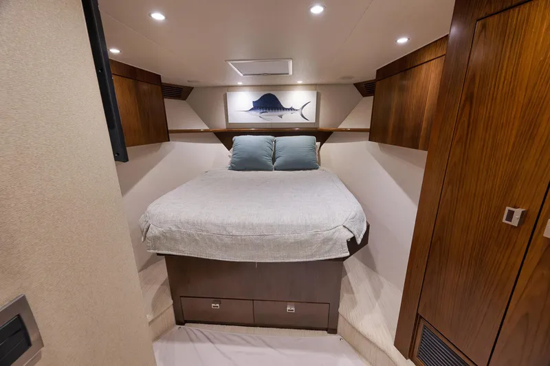 Slide: The Image of Luxurious cabin interior of 2015 Viking 76 Enclosed Bridge yacht with cozy bed and wooden accents. - 42